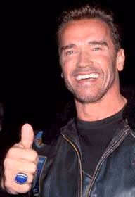 Smiling man in a black leather jacket giving a thumbs-up