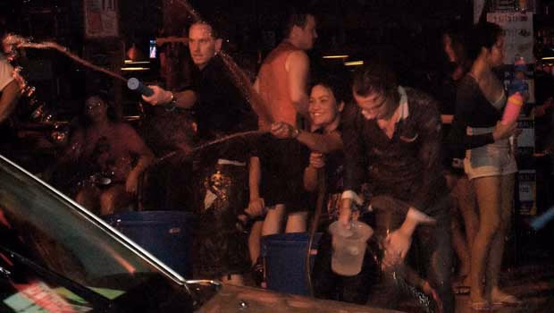 Songkran People Throwing Water At Car
